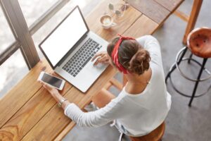 Woman working on a laptop on how to advertise