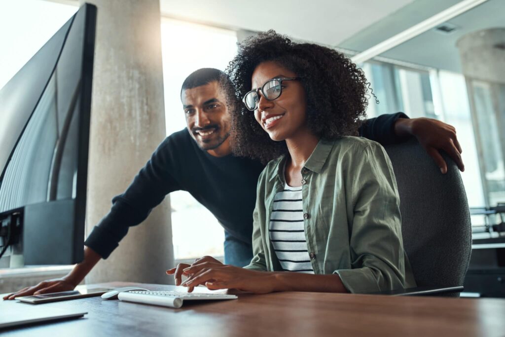 Two Professional Business People Working Together In Office