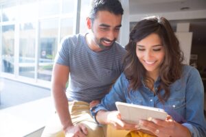 A couple helping each other to make Instagram post