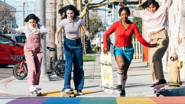 girls crossing the street with skates with colorful styles