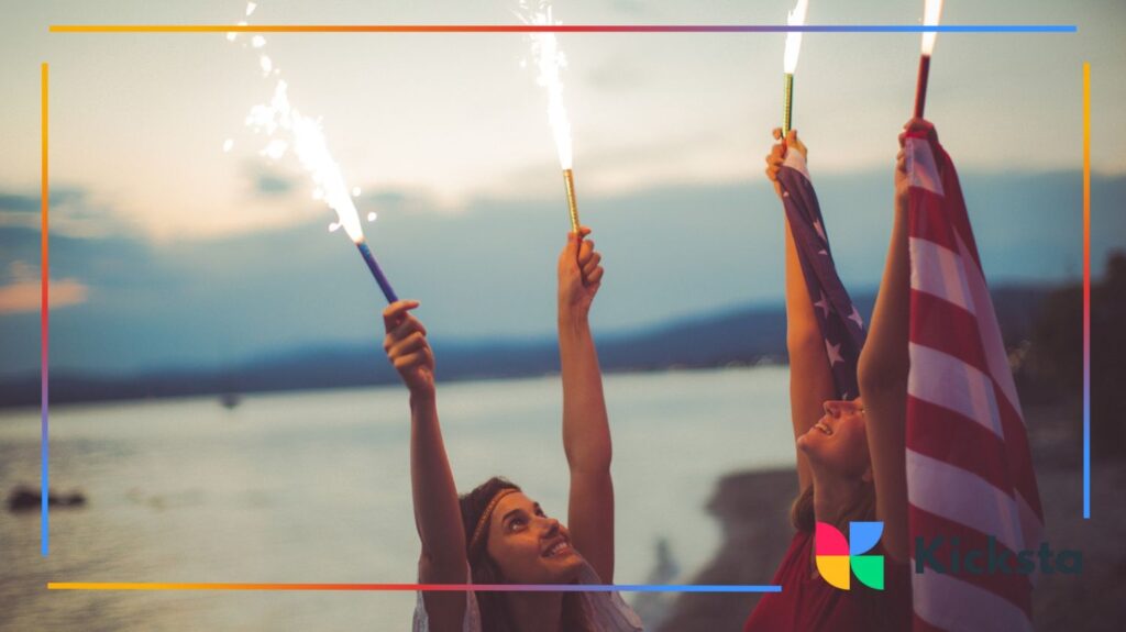 Girls holding sparklers and US flag